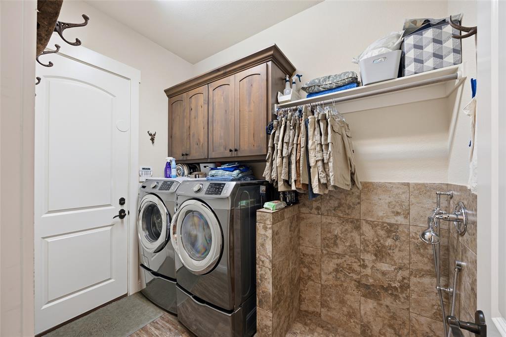 3105 Pastor Street Dallas, TX 75212 - Photo 25 of 28 Laundry room with cabinet space and washing machine and dryer, with a cool dog shower station
