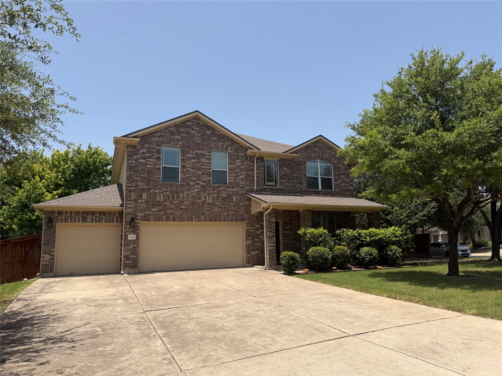 3021 Grand Mission Way Pflugerville, TX 78660 - Photo 3 of 31 A well-maintained two-story residence with a brick facade and ample parking space.