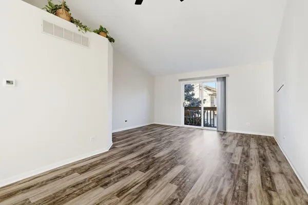 a view of a room with wooden floor and white walls