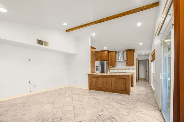 a view of a kitchen with a sink and a refrigerator