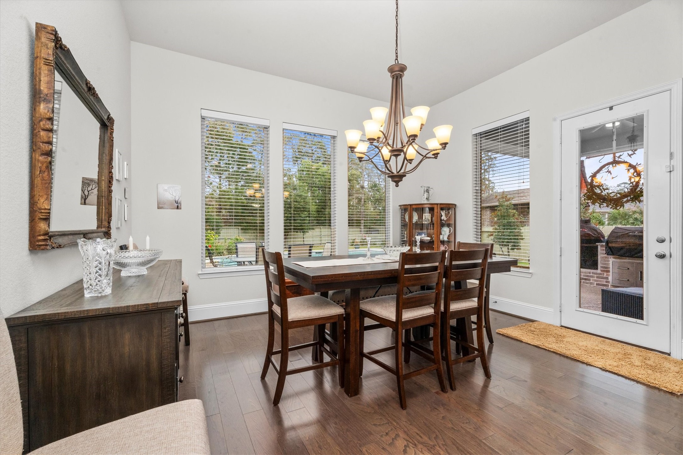 106 Amber Jade Court Conroe, TX 77304 - Photo 11 of 50 a view of a dining room with furniture window and wooden floor