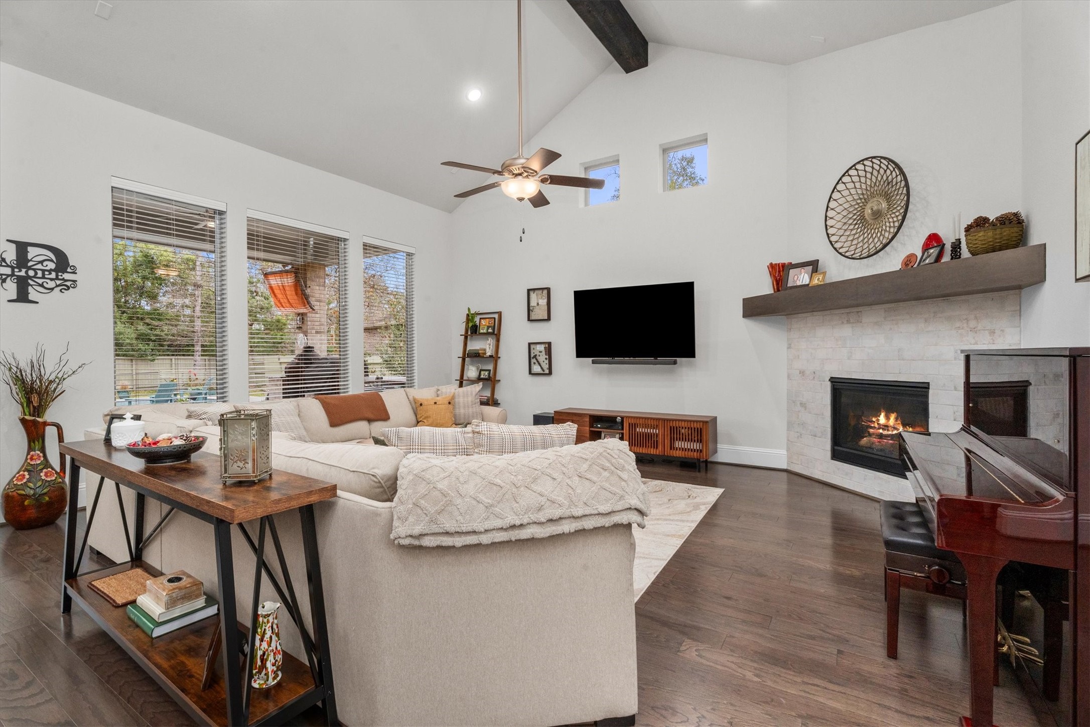 106 Amber Jade Court Conroe, TX 77304 - Photo 49 of 50 a living room with furniture a flat screen tv and a fireplace