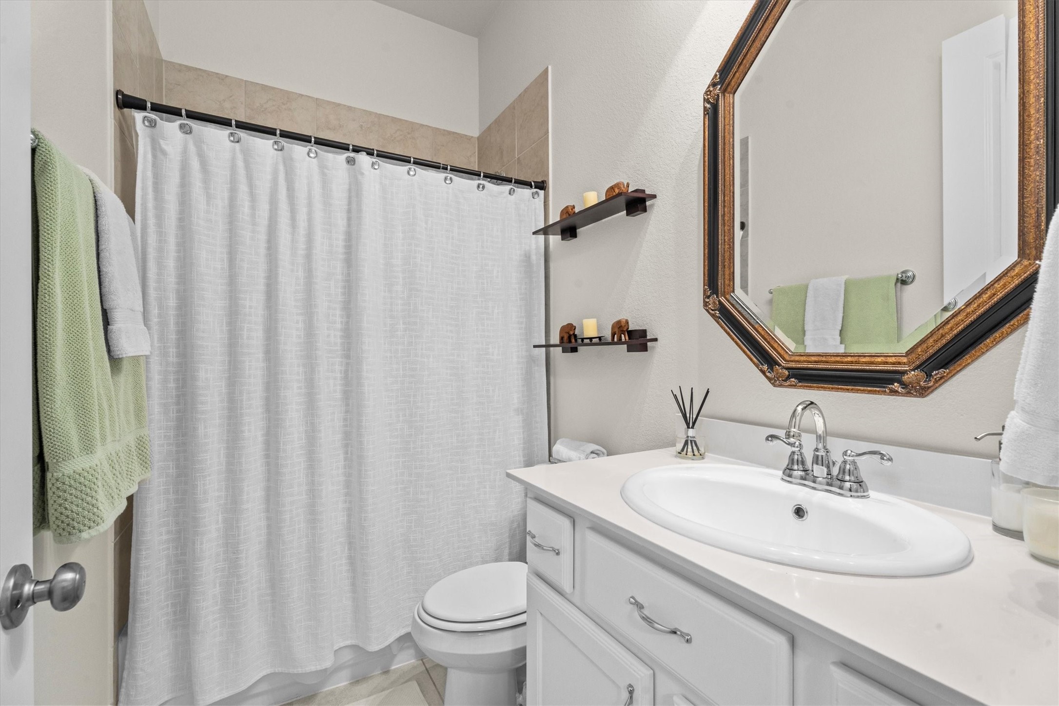 106 Amber Jade Court Conroe, TX 77304 - Photo 20 of 50 a bathroom with a sink a toilet and a mirror