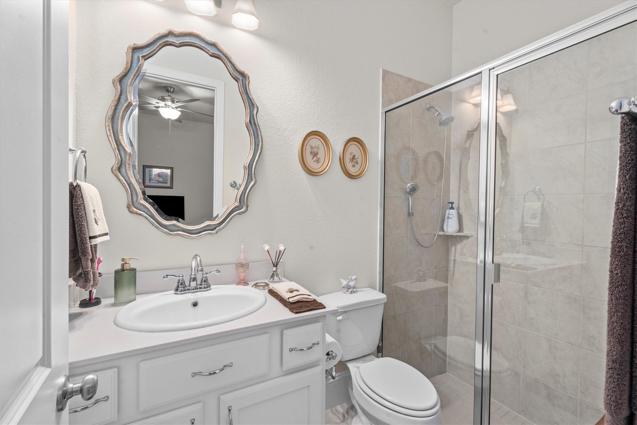 106 Amber Jade Court Conroe, TX 77304 - Photo 22 of 50 a bathroom with a toilet a sink and a mirror