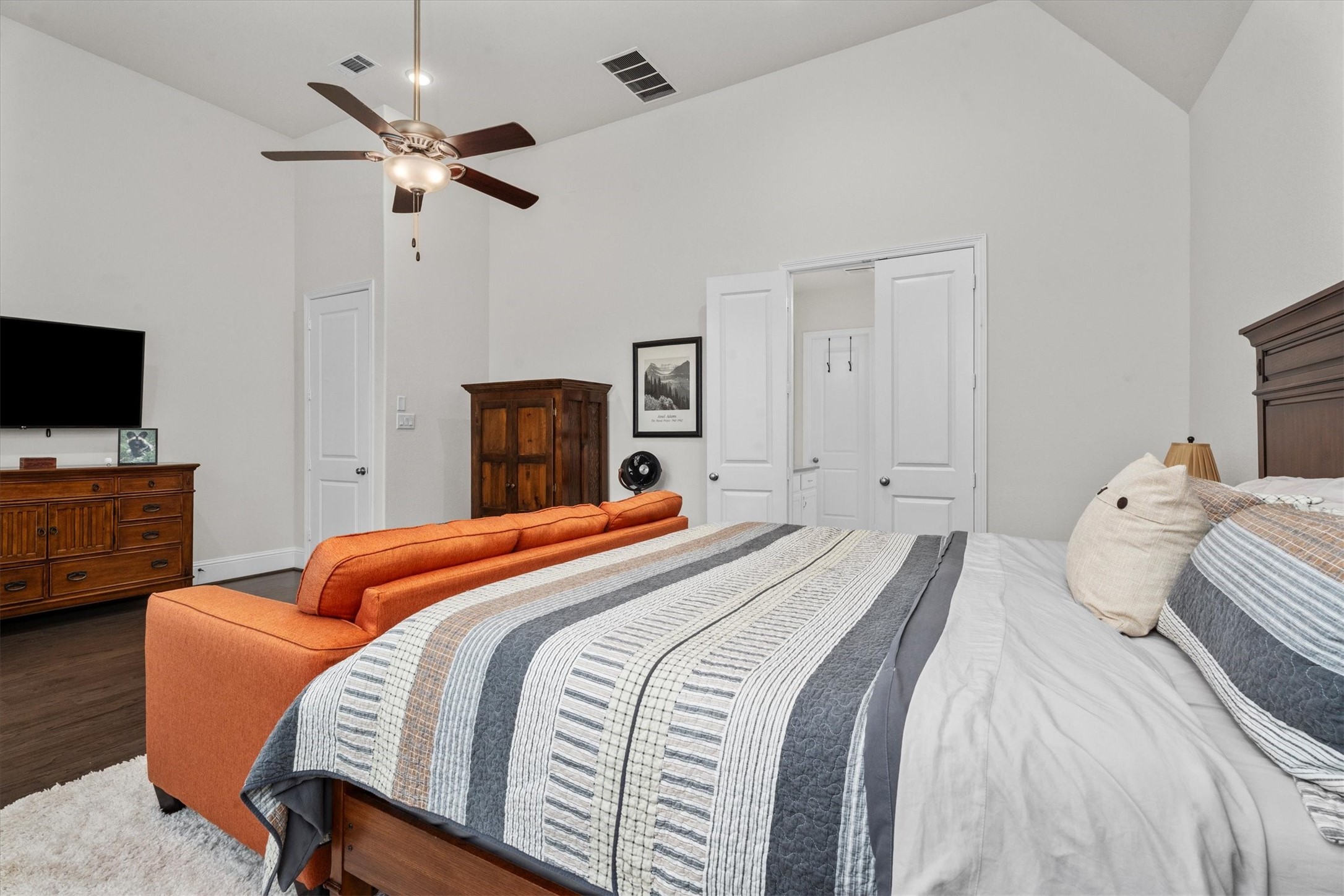 106 Amber Jade Court Conroe, TX 77304 - Photo 25 of 50 a bedroom with a bed and a flat screen tv