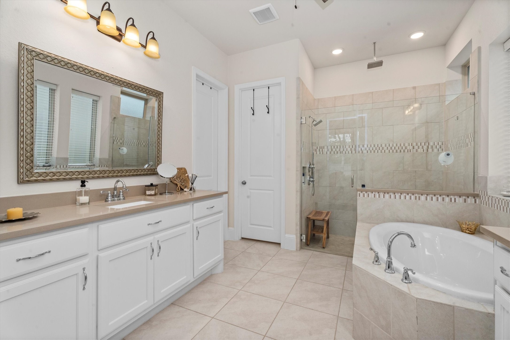 106 Amber Jade Court Conroe, TX 77304 - Photo 29 of 50 a bathroom with a granite countertop sink a mirror a shower and a bathtub