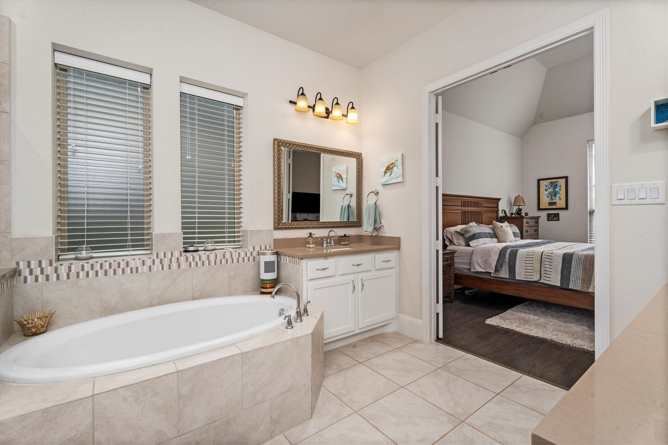 106 Amber Jade Court Conroe, TX 77304 - Photo 30 of 50 a bathroom with a tub sink and mirror