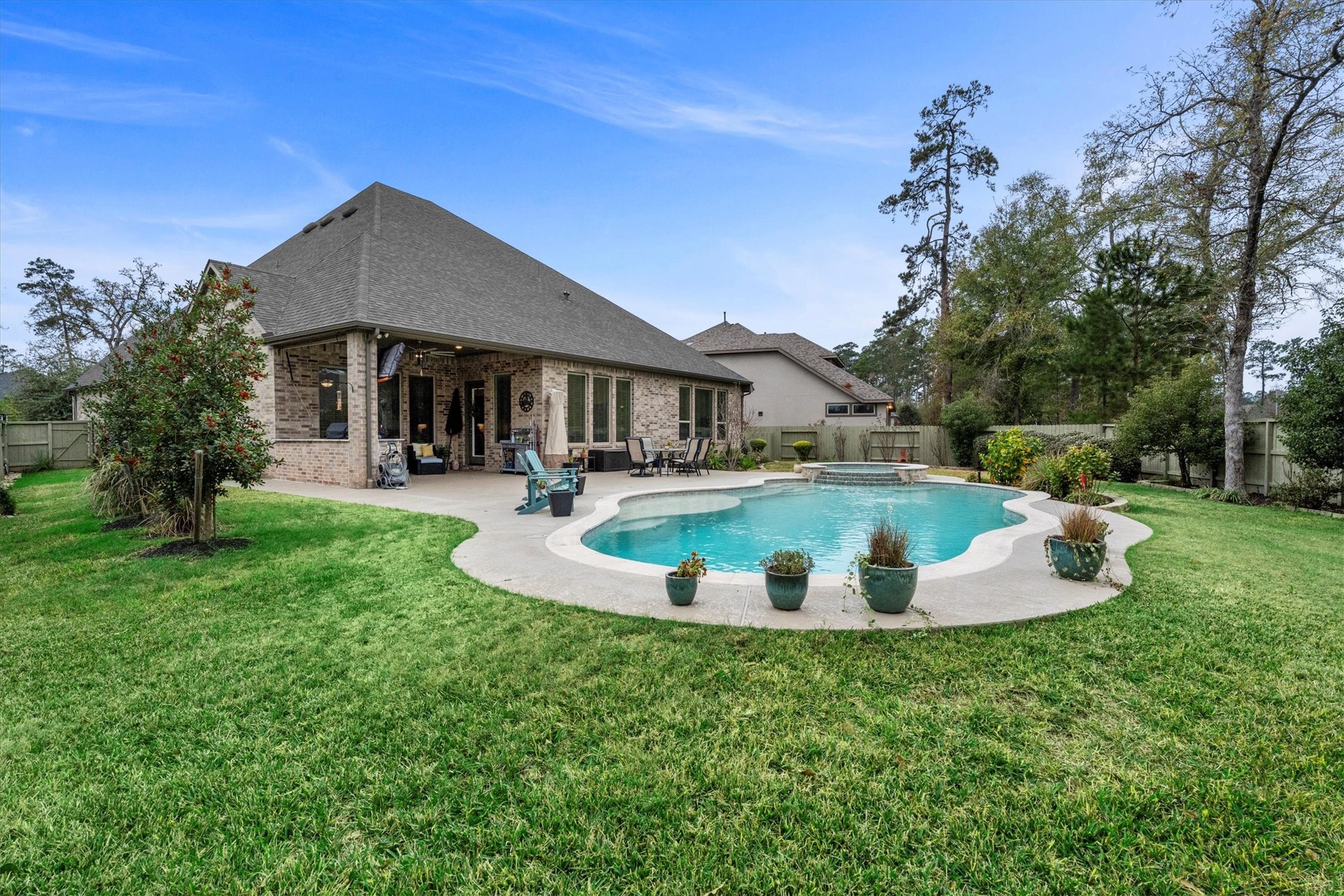 106 Amber Jade Court Conroe, TX 77304 - Photo 35 of 50 a view of a house with a backyard porch and sitting area