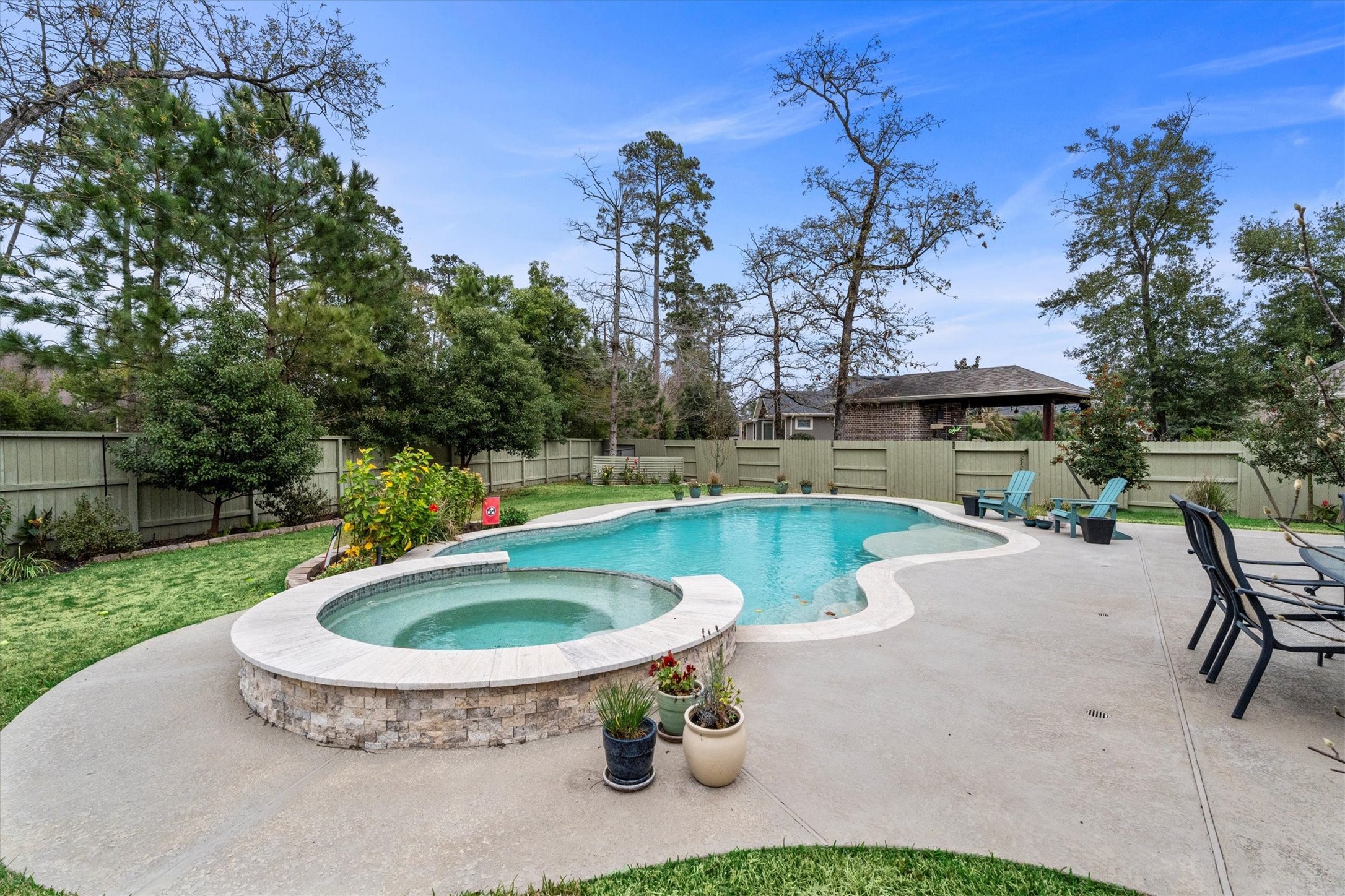 106 Amber Jade Court Conroe, TX 77304 - Photo 36 of 50 a view of a swimming pool with a patio