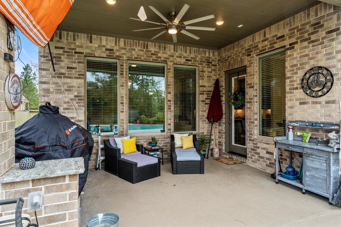 106 Amber Jade Court Conroe, TX 77304 - Photo 37 of 50 a living room with furniture a ceiling fan and a large window