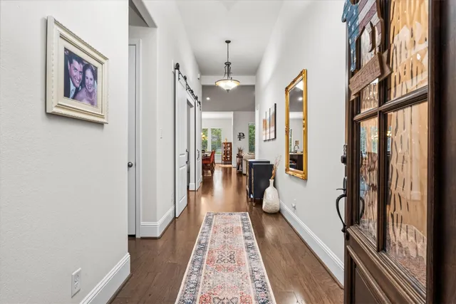 a living room with furniture a rug and a bookshelf