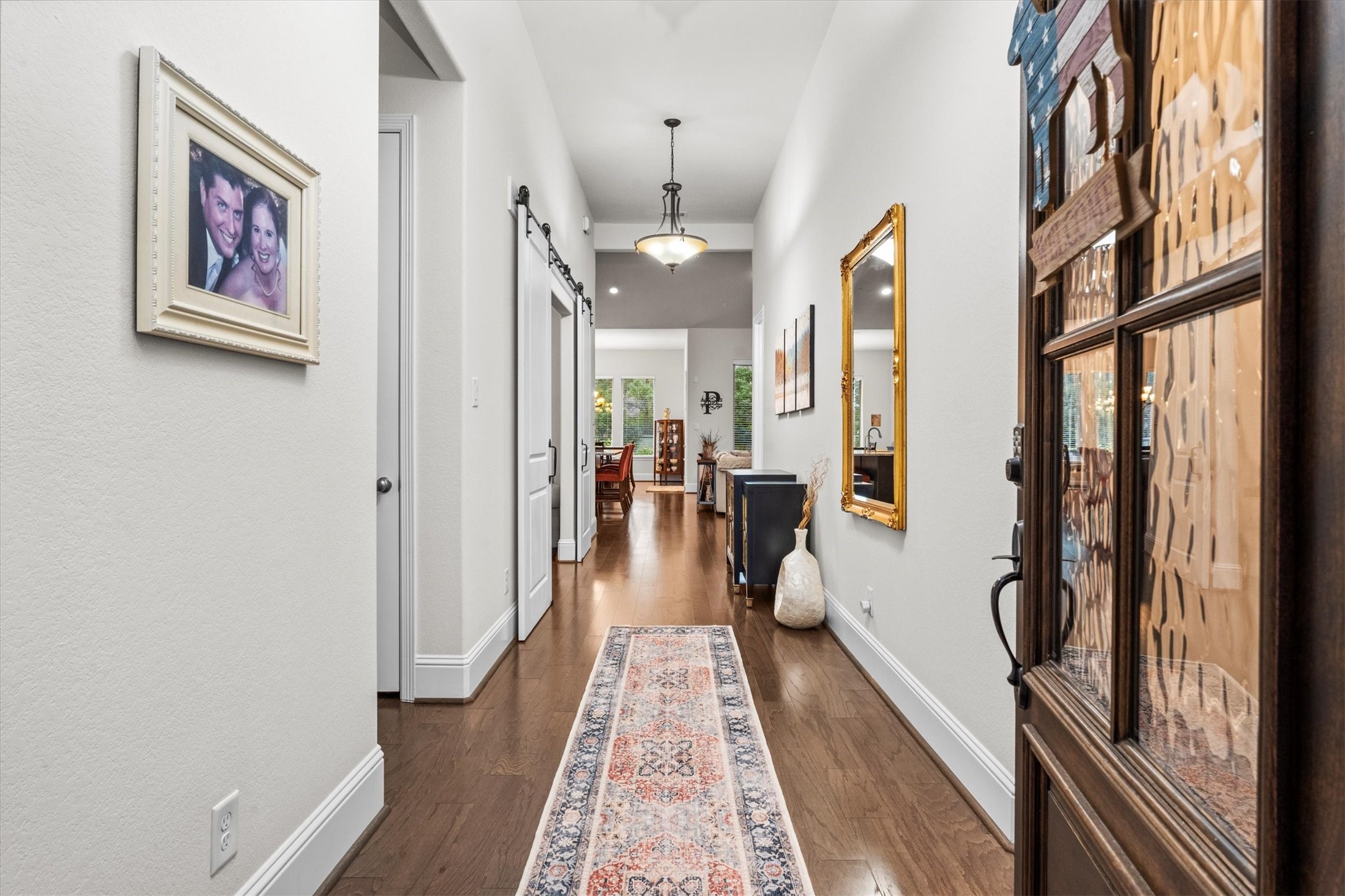 106 Amber Jade Court Conroe, TX 77304 - Photo 4 of 50 a view of a hallway with wooden floor and furniture