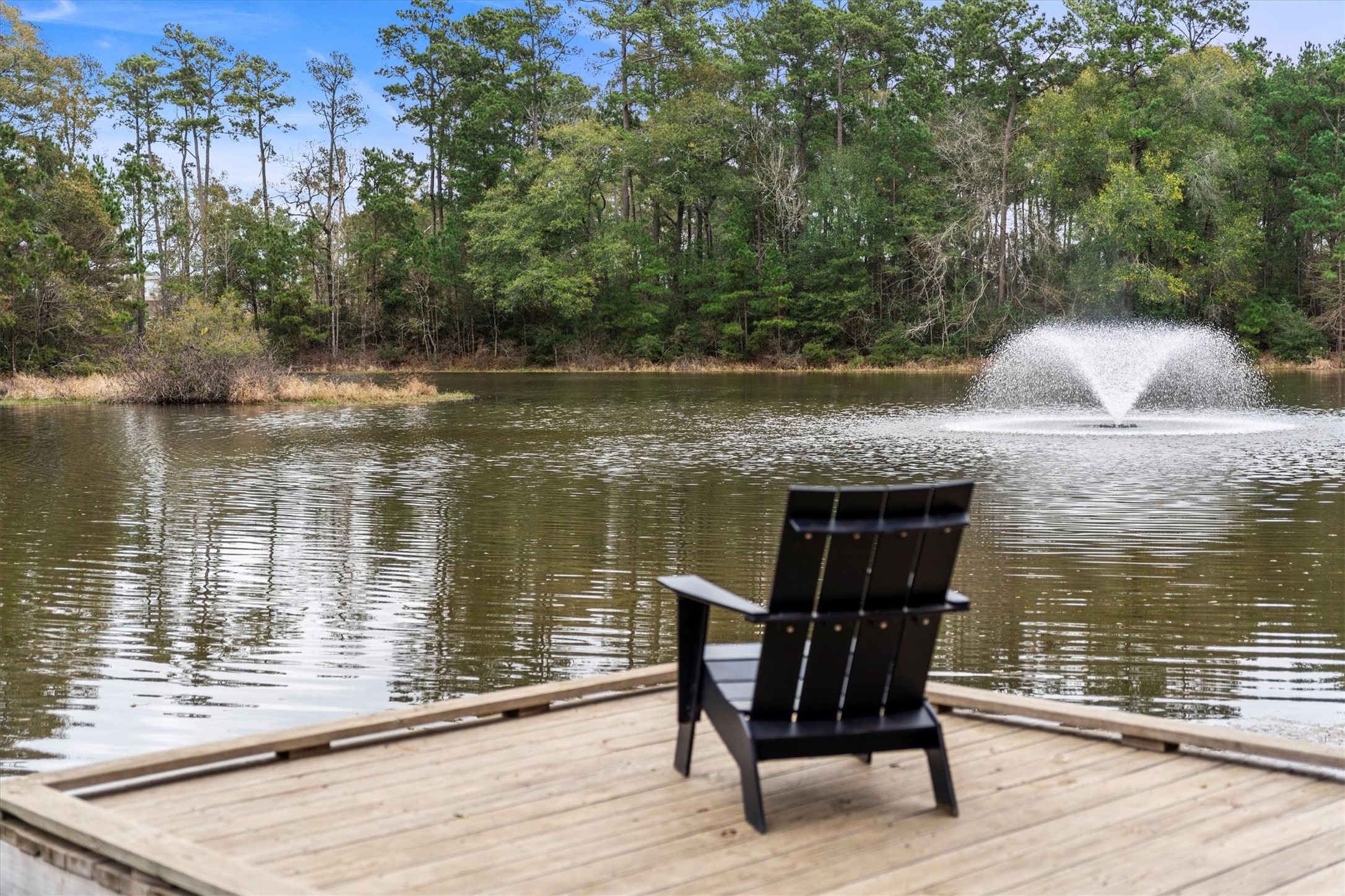 106 Amber Jade Court Conroe, TX 77304 - Photo 42 of 50 a view of a lake with table and chairs