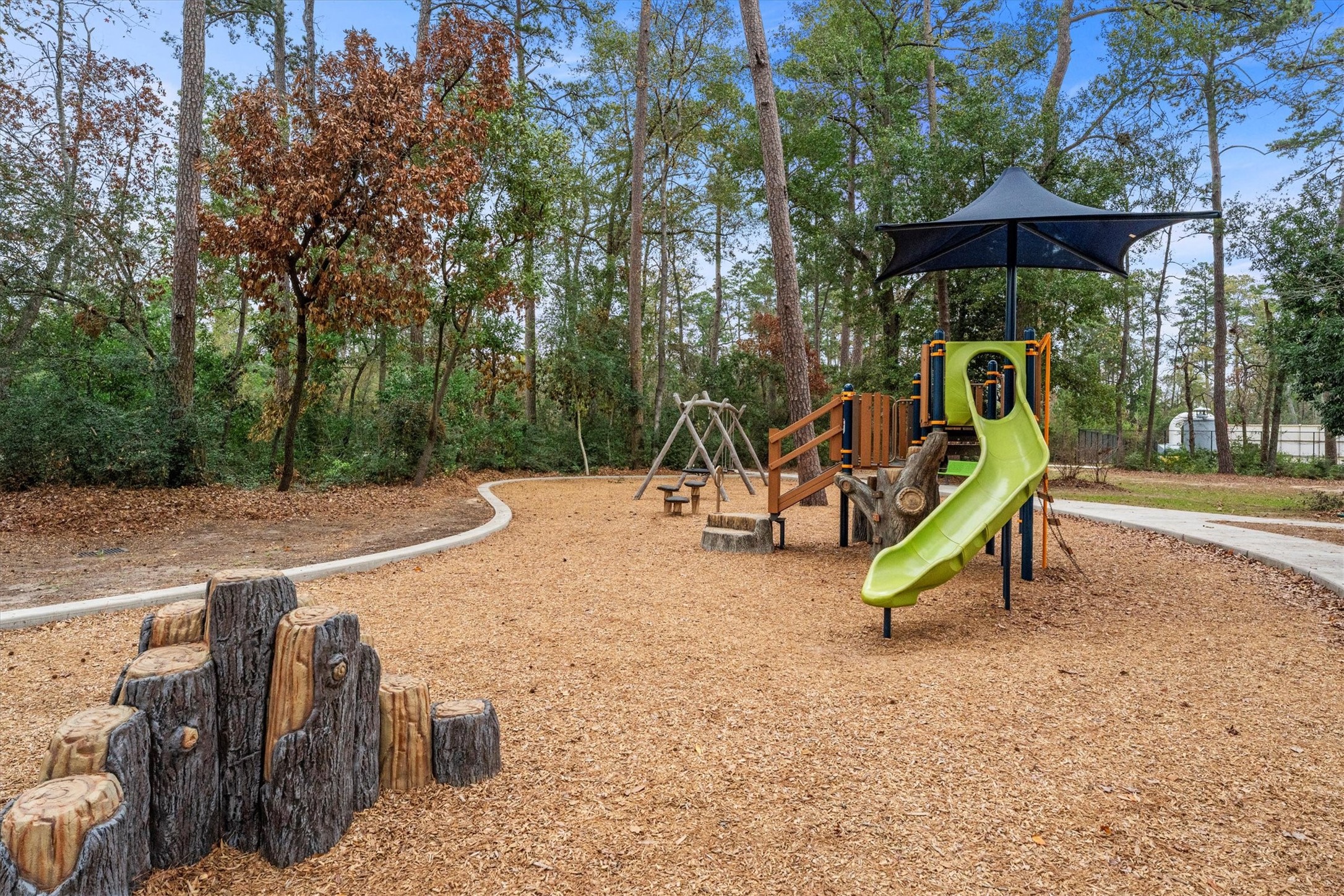 106 Amber Jade Court Conroe, TX 77304 - Photo 45 of 50 a view of a park with slide