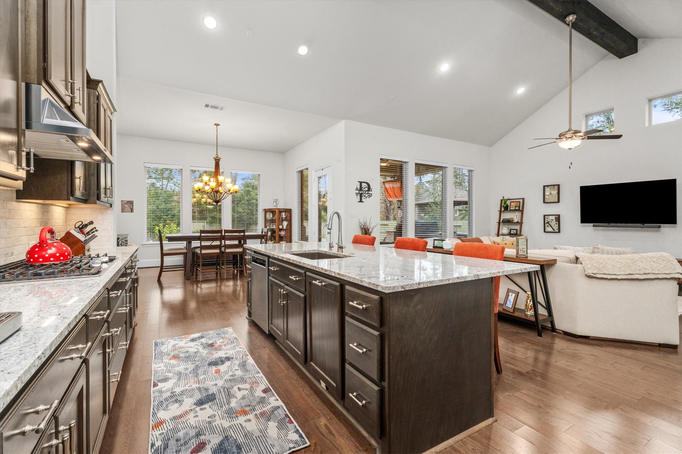 106 Amber Jade Court Conroe, TX 77304 - Photo 6 of 50 a kitchen with stainless steel appliances granite countertop a stove and a wooden floor