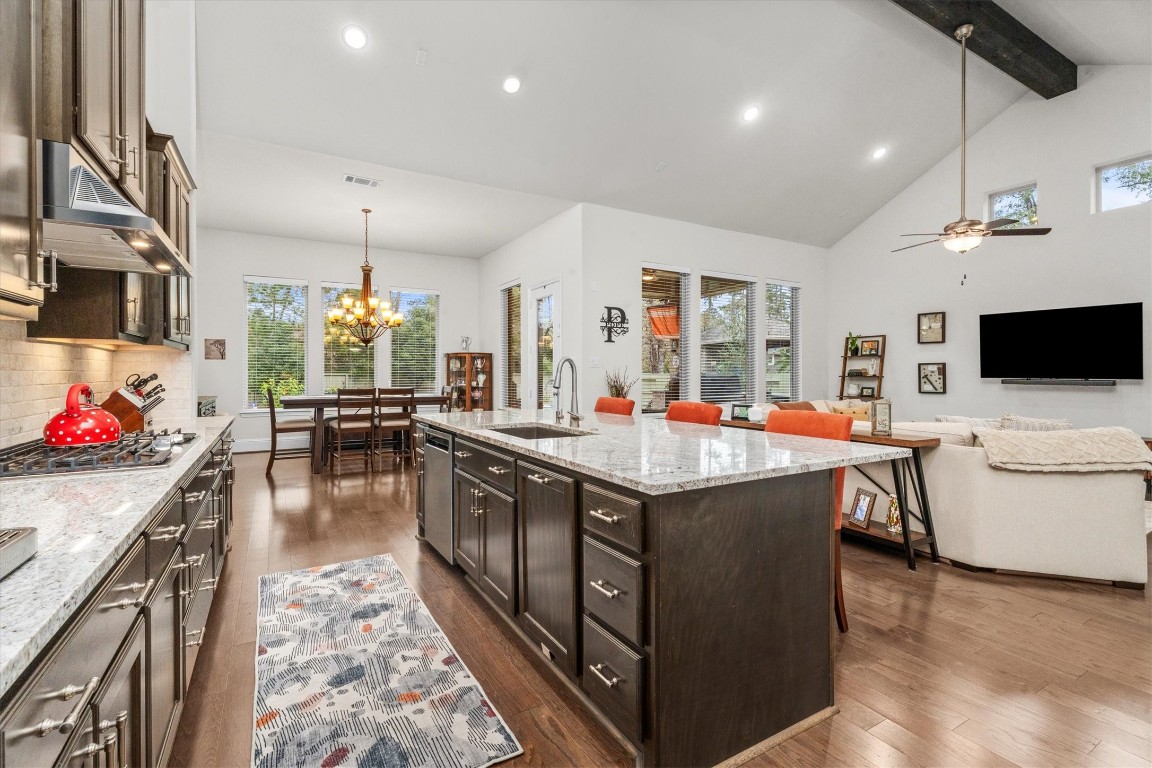 106 Amber Jade Court Conroe, TX 77304 - Photo 6 of 50 a kitchen with stainless steel appliances granite countertop a stove and a wooden floor