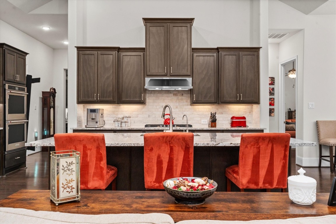 106 Amber Jade Court Conroe, TX 77304 - Photo 8 of 50 a kitchen with stainless steel appliances kitchen island granite countertop a refrigerator and stove