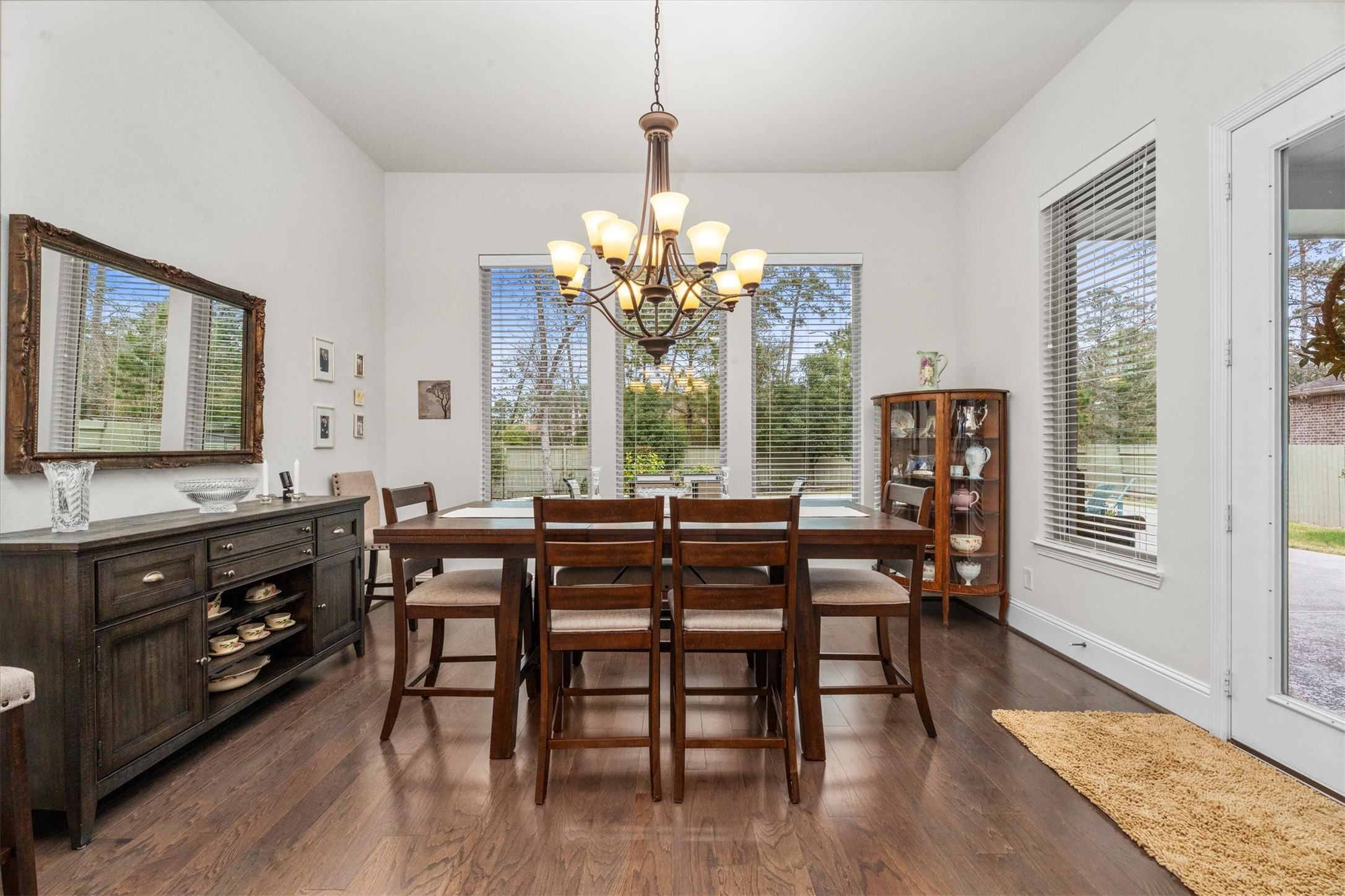 106 Amber Jade Court Conroe, TX 77304 - Photo 10 of 50 a view of a dining room with furniture a chandelier and wooden floor