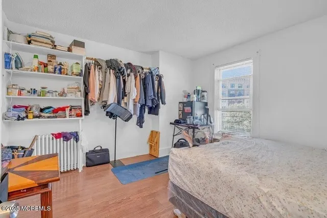 a view of a bedroom with clothes shoes and a couch