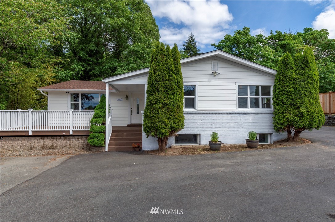 2107 Crystal Springs Road University Place, WA 98466 - Photo 1 of 23 a view of a house with a yard and garage