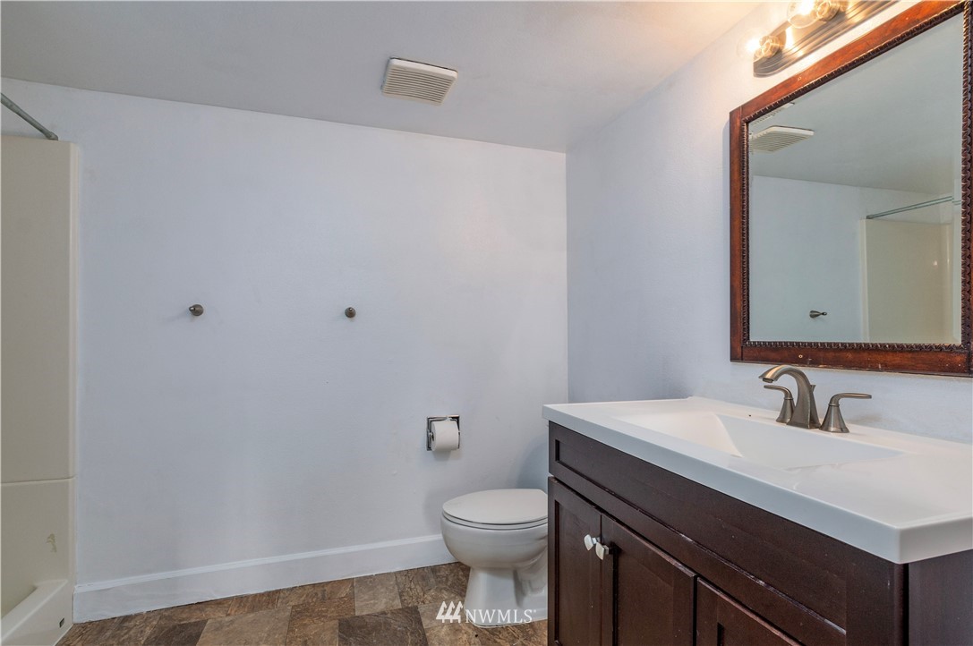 2107 Crystal Springs Road University Place, WA 98466 - Photo 14 of 23 a bathroom with a sink a toilet and mirror