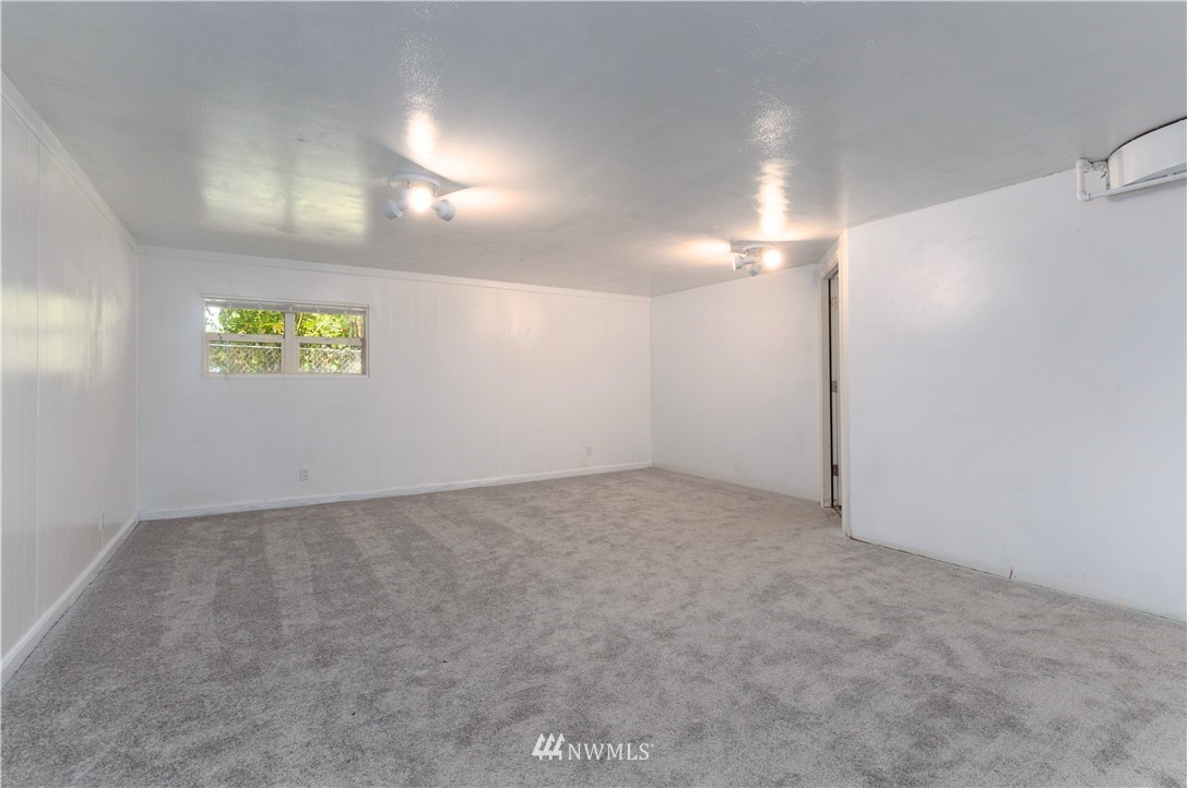 2107 Crystal Springs Road University Place, WA 98466 - Photo 15 of 23 an empty room with windows and ceiling fan