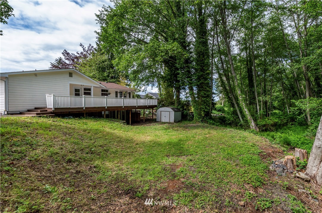 2107 Crystal Springs Road University Place, WA 98466 - Photo 22 of 23 a view of a house with a backyard and a patio