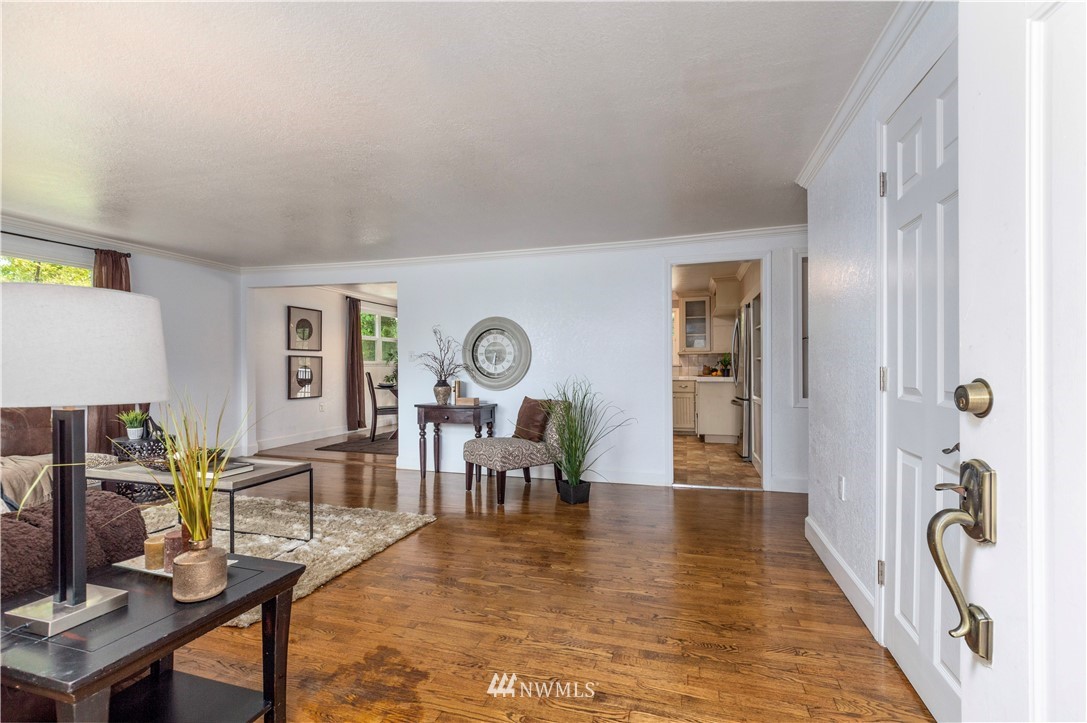 2107 Crystal Springs Road University Place, WA 98466 - Photo 5 of 23 a living room with furniture a dining table and a potted plant