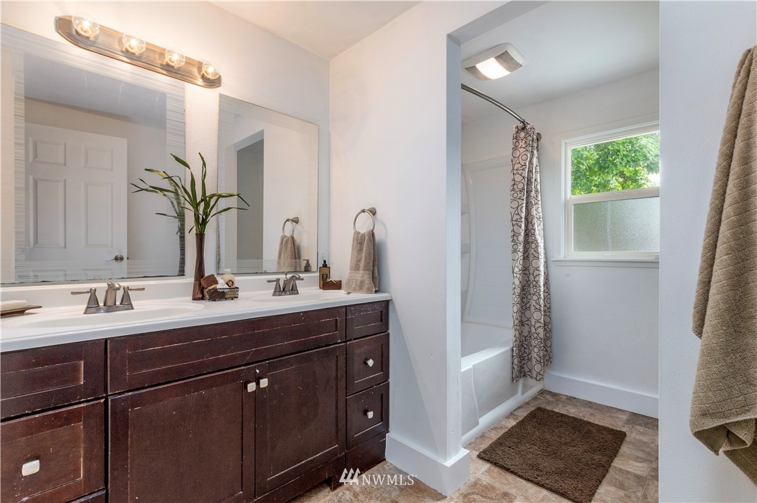 2107 Crystal Springs Road University Place, WA 98466 - Photo 9 of 23 a bathroom with a double vanity sink and a mirror