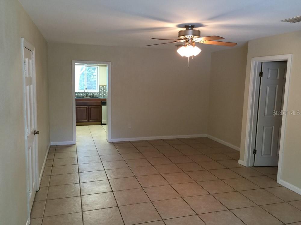631 Northwest 34th Terrace Gainesville, FL 32607 - Photo 2 of 14 a view of an empty room with a chandelier fan and a window