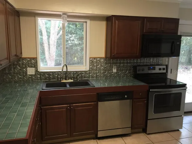 a kitchen with a sink stove and microwave