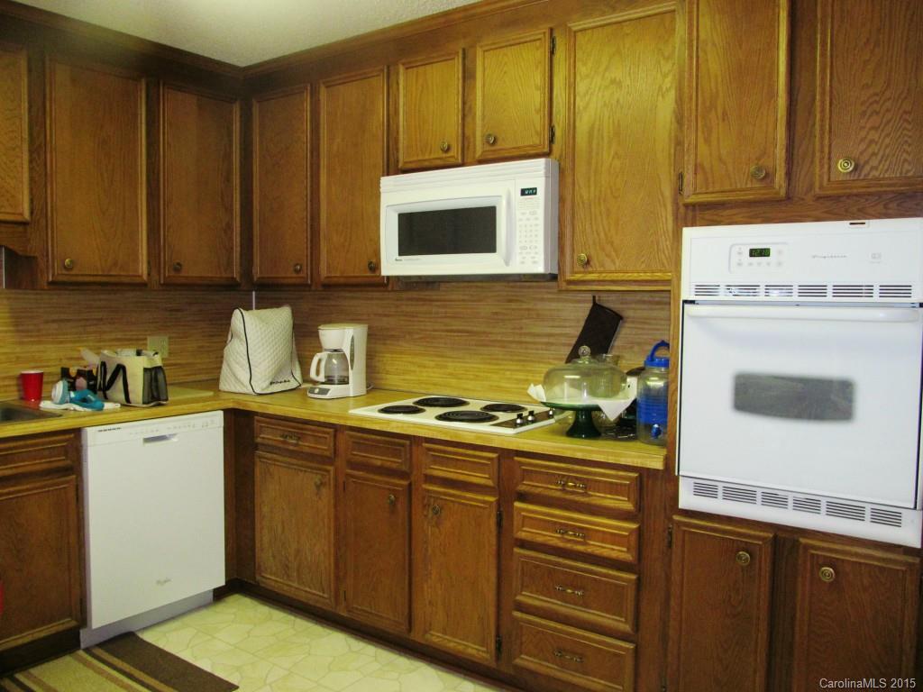 205 Timberfield Trail, Unit 76 China Grove, NC 28023 - Photo 4 of 8 a kitchen with a stove and a cabinets