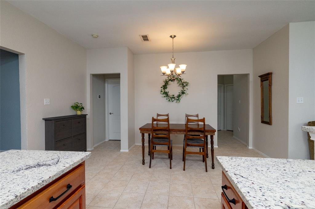 4025 Chisos Rim Trail Fort Worth, TX 76244 - Photo 16 of 40 Spacious dining area featuring neutral wall tones, tile flooring, and a chandelier lighting fixture