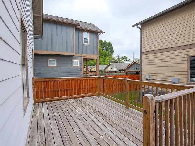 a view of balcony with wooden floor and fence