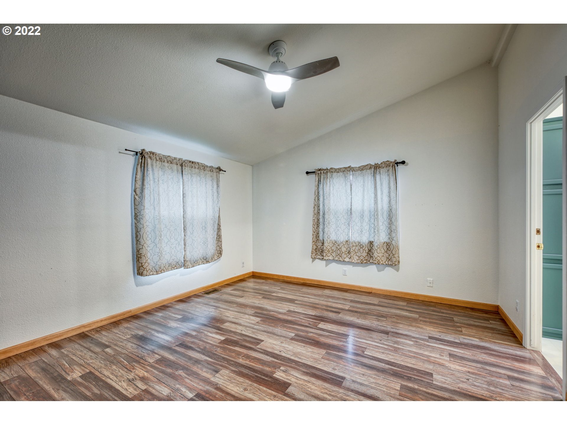 82226 Rattlesnake Road Dexter, OR 97431 - Photo 18 of 32 a view of an empty room with wooden floor and a window