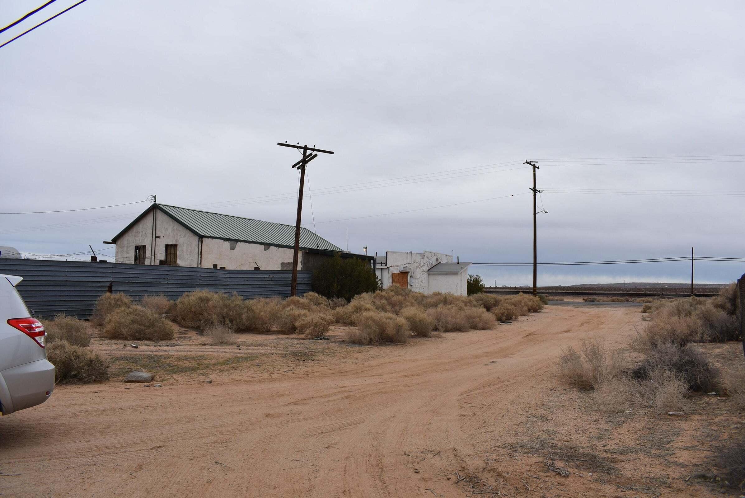 26197 Twenty Mule Team Road Boron, CA 93516 - Photo 9 of 14 a bedroom with a bed and a chandelier