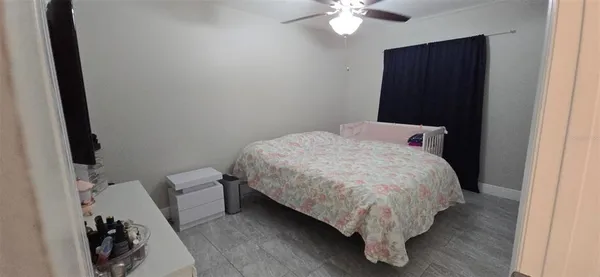 a bed sitting in a bedroom next to a bathroom