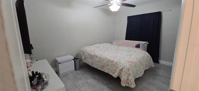 a bed sitting in a bedroom next to a bathroom