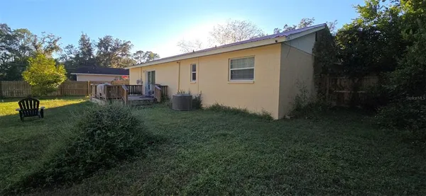 a view of backyard of house with outdoor seating and green space