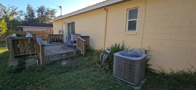 a view of a backyard with plants and a grill