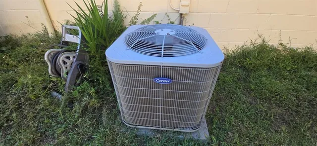 a view of an empty room with a fireplace and a window