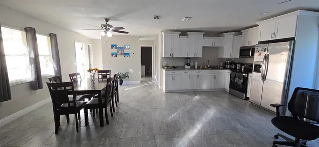 a view of a dining room with furniture and a chandelier