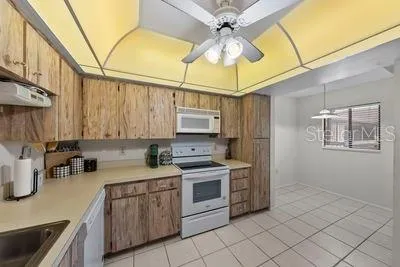 a kitchen with a stove cabinets and a sink