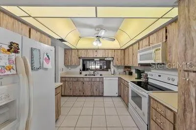 a kitchen with stainless steel appliances granite countertop a sink and cabinets