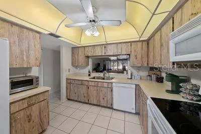a kitchen with stainless steel appliances a sink a stove and cabinets