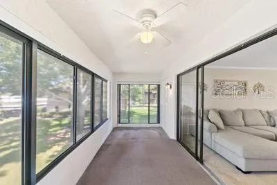 a view of a big room with windows and chandelier