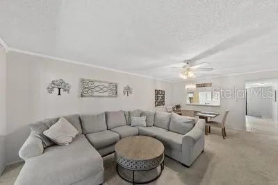 a living room with furniture and a dining table