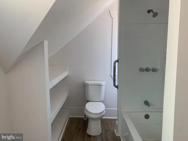 a bathroom with a toilet and a shower