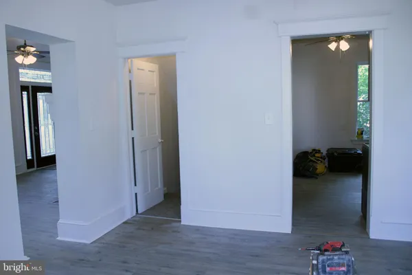 an empty room with wooden floor cabinet and closet