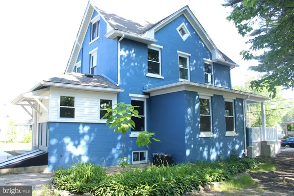 a front view of a house with plants